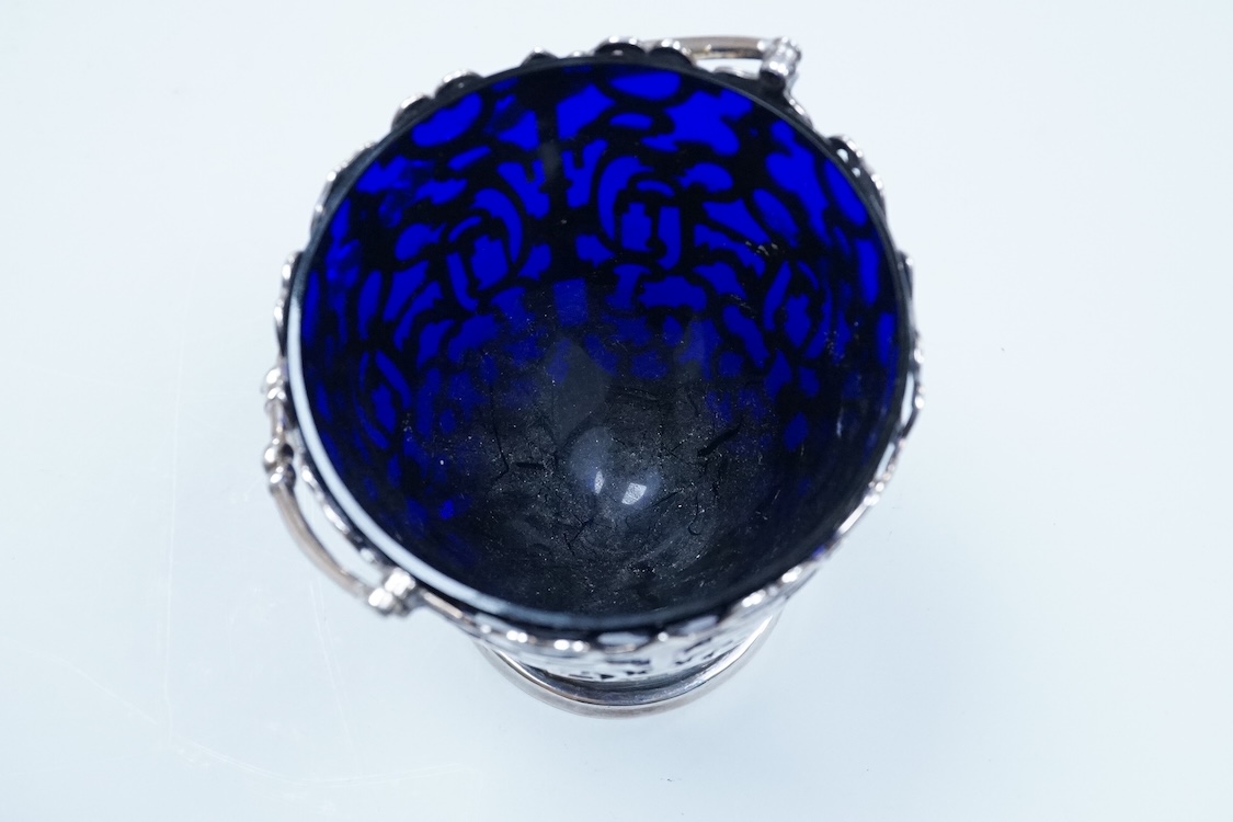 A Victorian pierced silver sugar basket with blue glass liner, makers mark rubbed, London, 1851, height excluding handle, 13.2cm, 7.9oz.